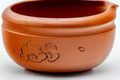Close-up of the engraved floral design carved into the red clay body of the katakuchi.