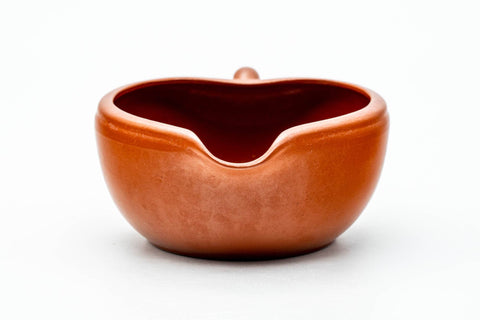 Front view from slightly above, showing the wide mouth and pinched pouring spout.