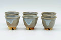 The two guinomi teacups grouped together, showing their interiors.