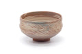 Pink-white hakeme chawan, front view showing the streaky white slip over the warm clay body