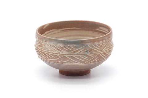 Pink-white hakeme chawan, front view showing the streaky white slip over the warm clay body