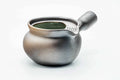 Dark metallic yohen lidless side-handle kyusu, three-quarter view showing the open mouth and green-tinged interior