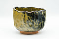 Japanese Matcha Bowl - Black and Yellow Undulating Wabi-Sabi Chawan - 450ml - side view of the black and yellow glaze