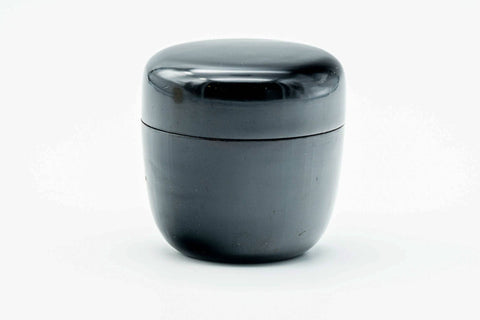 Small black-urushi ko-natsume matcha caddy, lid on, three-quarter view