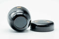 Black-lacquer soaring-bird matcha tea caddy, body lying on its side with the lid lying flat, showing the lid underside