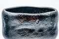 Close-up of the textured black raku glaze and rim