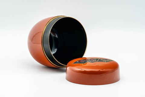 Japanese Natsume - Orange Gold Floral Lacquered Matcha Tea Caddy - 100ml - open caddy with the lid set in front, showing the black interior and the underside of the lid