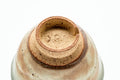 Inverted view of a cup showing the unglazed foot ring and base.