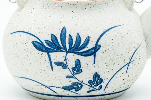 Japanese Dobin - Blue Floral White Textured Arita-yaki Porcelain Teapot - 500ml - closeup of the blue floral decoration on the textured white porcelain