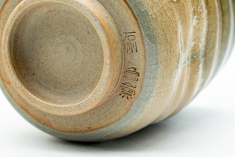 Close-up of the body highlighting the spiral ridges and pooling drip glaze.