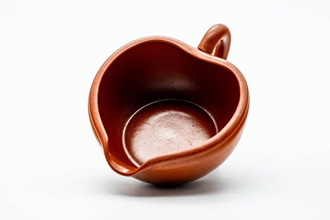 Angled view into the mouth of the yuzamashi, showing the smooth interior and spout.
