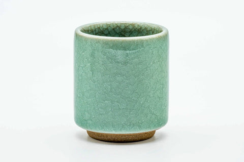 Side view of the celadon teacup, showing the crackled green glaze.