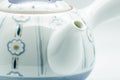 Close-up of the blue chrysanthemum-and-stripe decoration on the teapot body