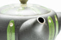 Close-up of the teapot's shoulder and lid detail.