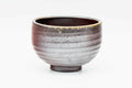 Three-quarter view of the Bizen chawan showing the ash-gradient glaze and ribbed surface