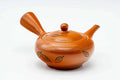 Red shudei Tokoname-yaki side-handle kyusu teapot, three-quarter view with lid on and spout to the left