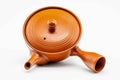 Overhead view of the wide red kyusu, lid on, showing the handle and spout.