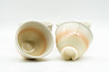 The Hagi teacups tilted, one on its side showing the unglazed foot