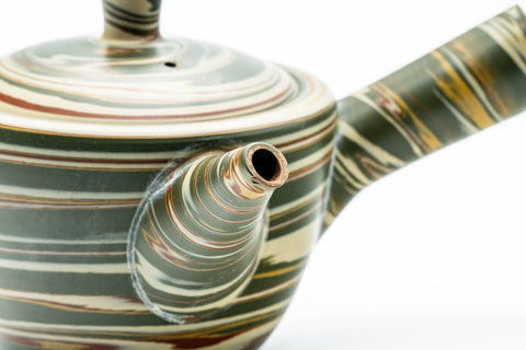 Angled view highlighting the side handle and the swirled marbled clay body.