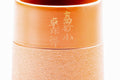 Close-up of the smooth upper body, showing the painted gold kanji.