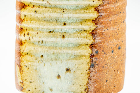 Close-up of the ribbed body and ash-glaze speckling.