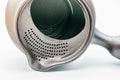 Interior closeup of the dark yohen kyusu showing the integrated mesh strainer holes and green interior