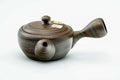 Dark green nerikomi Tokoname-yaki side-handle kyusu teapot, three-quarter view with the handle to the left and lid on, showing the marbled clay body