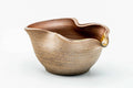 Ash-glazed katakuchi water cooler with a wavy rim, pale exterior and glossy amber interior, front three-quarter view.