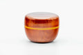 Closer front view of the closed orange lacquer ko-natsume highlighting the horizontal gold band.
