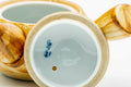 Underside of the kyusu showing the glazed foot and a blue maker's mark.