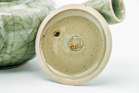 Underside of the green celadon Obori Soma kyusu showing the unglazed clay foot and stamp