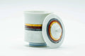 Angled view of the lidded cup detailing the coloured bands on the lid and body.