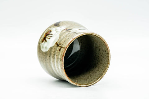 Angled overhead view looking into the yunomi's mouth, revealing the dark glazed interior and rim.