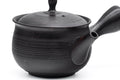 Spiraling benishibori Tokoname teapot, angled view of the ribbed black body