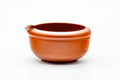 The katakuchi water cooler viewed from the side, highlighting its rounded reddish-brown clay body and pouring spout.