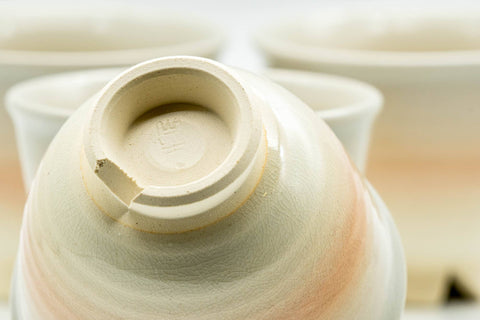Overhead view down into a Hagi teacup showing the spiraling glazed interior, with the others alongside