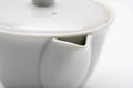 Close-up of the white porcelain glaze where the lid meets the body and spout.