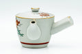 Three-quarter view of the kyusu showing its hollow side handle and short spout.