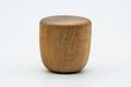 Front view of the closed wooden canister with its rounded domed lid.