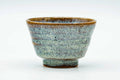 Side view of the teacup, showing the streaked hare's-fur glaze.