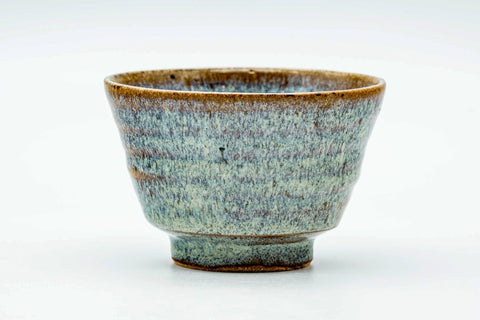 Side view of the teacup, showing the streaked hare's-fur glaze.