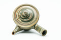 Overhead view of the domed lid and knob, with concentric marbled rings.