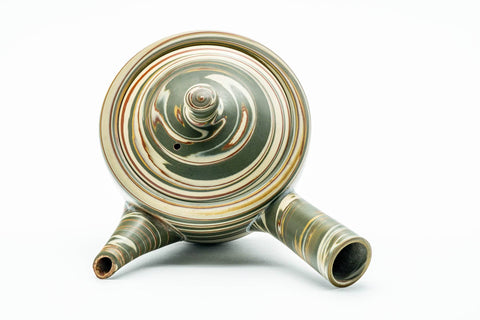 Overhead view of the domed lid and knob, with concentric marbled rings.