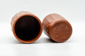 Japanese Teacups - Pair of Carved Red Shudei Tokoname-yaki Meoto Yunomi - one cup on its side beside an upright cup, showing the carved texture
