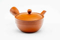 Front view of the wide red kyusu, lid on.
