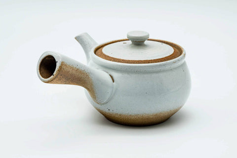 Side view of the white kyusu with the handle to the left, lid on.