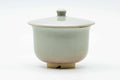 Pale beige Hagi-yaki lidded yunomi teacup, lid on, front view.