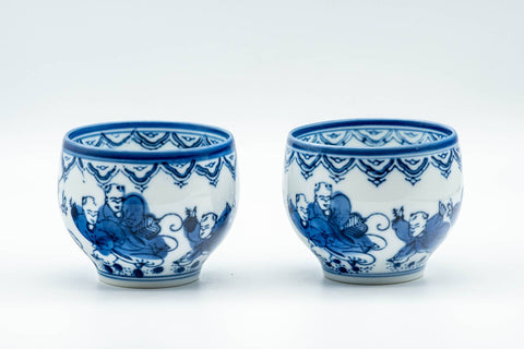 Japanese Teacups - Pair of Playful Villagers Arita-yaki Yunomi - 130ml - front view of the pair showing the blue villagers motif