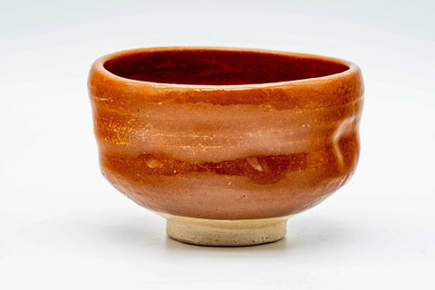 Front view of the aka-raku chawan showing the glossy red glaze
