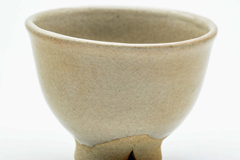 Close-up of a single teacup, showing the soft beige glaze.